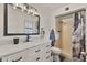 Stylish bathroom featuring a marble countertop vanity, modern fixtures, and a shower with updated tiling at 5045 W Mescal St, Glendale, AZ 85304