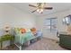 Bright, airy bedroom with a daybed, ceiling fan, and a view from the window at 5045 W Mescal St, Glendale, AZ 85304