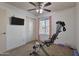 Bedroom showcasing a recumbent bike, a ceiling fan, and closet space at 5045 W Mescal St, Glendale, AZ 85304