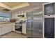 Well-lit kitchen featuring stainless steel appliances and white cabinets at 5045 W Mescal St, Glendale, AZ 85304