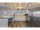 Well-lit kitchen featuring stainless steel appliances, a center island, and ample cabinet space at 5045 W Mescal St, Glendale, AZ 85304