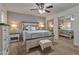 Comfortable main bedroom with neutral tones, a ceiling fan, and mirrored closet doors for ample storage at 5045 W Mescal St, Glendale, AZ 85304