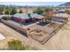 Aerial view of the home, featuring a fenced yard, gravel landscaping, a covered patio, and a round above-ground pool at 50530 W Mockingbird Ln, Maricopa, AZ 85139