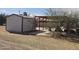 Backyard featuring the storage shed and open-air shelter on concrete pad, providing versatile outdoor space at 50530 W Mockingbird Ln, Maricopa, AZ 85139