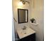 Bathroom featuring a modern vanity, mirror, and decorative shelf at 50530 W Mockingbird Ln, Maricopa, AZ 85139