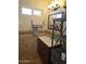 Bathroom featuring stylish vanity, decorative shelving, and tiled walls at 50530 W Mockingbird Ln, Maricopa, AZ 85139