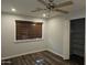 Bedroom featuring wood laminate flooring, a ceiling fan, and closet at 50530 W Mockingbird Ln, Maricopa, AZ 85139