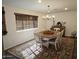 Bright dining room featuring classic chandelier, rug, and furnishings at 50530 W Mockingbird Ln, Maricopa, AZ 85139