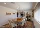 Charming dining room with a wood table, six chairs, and decorative accents at 50530 W Mockingbird Ln, Maricopa, AZ 85139