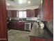 Kitchen featuring stainless appliances, dark countertops, and dark wood cabinets at 50530 W Mockingbird Ln, Maricopa, AZ 85139