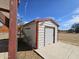 The storage shed in the backyard has a roll-up door and is situated on a concrete slab at 50530 W Mockingbird Ln, Maricopa, AZ 85139