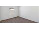 Simple bedroom with neutral walls, gray carpeting and a window at 5552 E Rock Bush Ln, San Tan Valley, AZ 85140