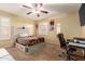 Bedroom with a queen bed, workspace, and ceiling fan at 5766 W Brown St, Glendale, AZ 85302