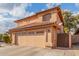 Two-story house with tan exterior, tile roof, and a two-car garage at 5766 W Brown St, Glendale, AZ 85302