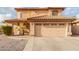 Two-story house with tan exterior, tile roof, and two-car garage at 5766 W Brown St, Glendale, AZ 85302