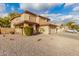 Two-story house with tan exterior, tile roof, and a two-car garage at 5766 W Brown St, Glendale, AZ 85302