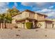 Tan two-story house with tile roof, landscaping, and a long driveway at 5766 W Brown St, Glendale, AZ 85302