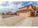 Two-story house with tan exterior, tile roof, and a two-car garage at 5766 W Brown St, Glendale, AZ 85302