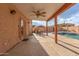 Relaxing patio with pool access, dining area, and ceiling fan at 5766 W Brown St, Glendale, AZ 85302