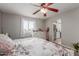 Bedroom with floral bedding, dresser, and ceiling fan at 6033 S 19Th Pl, Phoenix, AZ 85042