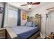 bedroom with a bed, ceiling fan, and playful decor at 6033 S 19Th Pl, Phoenix, AZ 85042