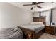 Bedroom with double bed, ceiling fan, and wood dresser at 6033 S 19Th Pl, Phoenix, AZ 85042