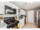 White kitchen with stainless steel appliances and ample counter space at 6033 S 19Th Pl, Phoenix, AZ 85042