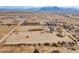 Aerial view of property showing house and large lot, distant mountains at 6210 N Poplar St, Maricopa, AZ 85139