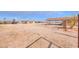 Large backyard with covered patio, shed, and expansive desert landscape at 6210 N Poplar St, Maricopa, AZ 85139