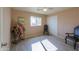 Bedroom with wood-look floors, ceiling fan, and two armchairs at 6210 N Poplar St, Maricopa, AZ 85139