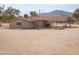 Tan house with covered patio and mountain views at 6210 N Poplar St, Maricopa, AZ 85139