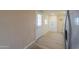 View of kitchen entry with light wood flooring and access door at 6210 N Poplar St, Maricopa, AZ 85139