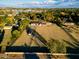 Aerial view of a ranch style home on a large lot with pasture at 6212 S 37Th St, Phoenix, AZ 85042