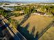 Aerial view of a ranch style home on a large lot with pasture at 6212 S 37Th St, Phoenix, AZ 85042