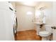 Clean bathroom with toilet, sink, and laundry area at 6212 S 37Th St, Phoenix, AZ 85042