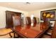 Formal dining room with a large wood table and leather chairs, offering ample seating at 6212 S 37Th St, Phoenix, AZ 85042