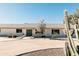 White brick home with a teal door and landscaped yard at 6212 S 37Th St, Phoenix, AZ 85042