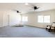 Spacious living room with gray carpet and ceiling fans at 6212 S 37Th St, Phoenix, AZ 85042