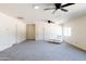 Large living room with gray carpet and ceiling fans at 6212 S 37Th St, Phoenix, AZ 85042