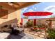 Relaxing backyard patio with seating area, umbrella, and landscaping at 625 N Hamilton St # 11, Chandler, AZ 85225