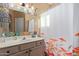 Bathroom with tiled shower, vanity, and decorative mirror at 625 N Hamilton St # 11, Chandler, AZ 85225