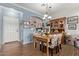 Bright dining area with wood table and floral chairs, adjacent to kitchen at 625 N Hamilton St # 11, Chandler, AZ 85225