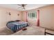 Spacious bedroom with ceiling fan and large window at 6252 E Billings St, Mesa, AZ 85205