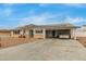 Ranch style home with carport, solar panels, and landscaped yard at 6252 E Billings St, Mesa, AZ 85205