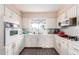 Efficient kitchen featuring white cabinets and modern appliances at 6252 E Billings St, Mesa, AZ 85205