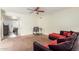 Living room with sectional sofa, built in shelving and ceiling fan at 6252 E Billings St, Mesa, AZ 85205