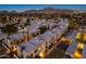 Wide aerial perspective shows modern residential neighborhood with desert mountain views at dusk at 6301 N 12Th St # 8, Phoenix, AZ 85014