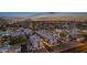 Nighttime aerial view of a community with illuminated homes and mountain backdrop at 6301 N 12Th St # 8, Phoenix, AZ 85014