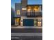 Modern two-story home featuring a blue garage door, brick accents, and a second-story balcony at 6301 N 12Th St # 8, Phoenix, AZ 85014