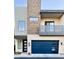 Modern two-story home featuring a private balcony and a blue garage door at 6301 N 12Th St # 8, Phoenix, AZ 85014